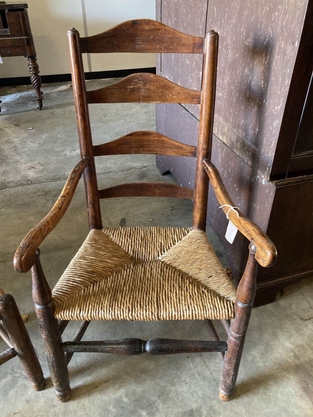 A set of eight rush seat ladderback dining chairs (two with arms)
